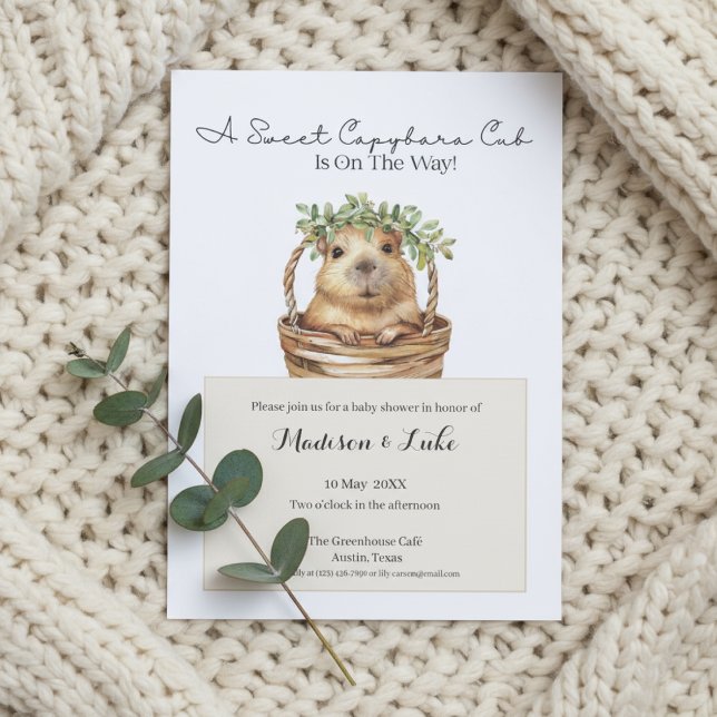Convite Capybara Baby Shower • Eucalyptus Design (Baby shower invitation with capybara design on cream knitted blanket and eucalyptus sprig)