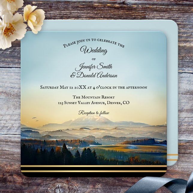 Convite Casamento Artístico Paisagem Montanha (Wedding invitation featuring a colorful landscape scene with mountains and a golden lining)
