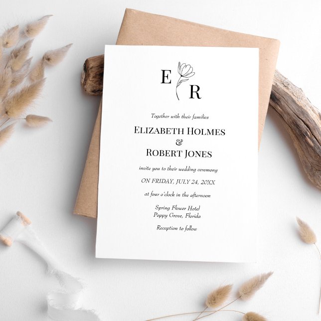 Convite de Casamento com Monograma Floral Preto e  (Elegant Black and White Floral Monogram Wedding Invitation on white table with neutral boho decor.)
