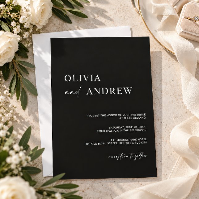 Convite de Casamento Minimalista Preto Simples (Simple black minimalist wedding invitation on a neutral table with olive branches and white flowers)