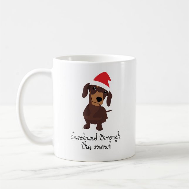 Daschund bonito através da caneca do Xmas da neve (Esquerda)
