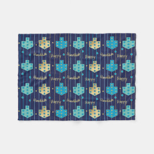 Dreidels no cobertor azul de velo de Hanukkah