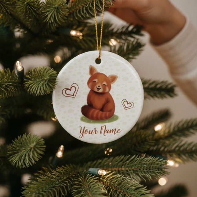 Enfeite Cerâmico Personalizado com Nome de Panda V (Cute red panda Christmas Ornament with hand-painted name, being hung on a tree for the holidays.)
