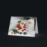 Festividades Papais noeis recebem um cartão de saudação<br><div class="desc">Papais noeis podem ter caído na neve,  mas um jovem doce está lá para ajudá-lo.</div>