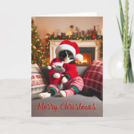 Festividades Tuxedo Cat segurando um cartão de Natal para o mou