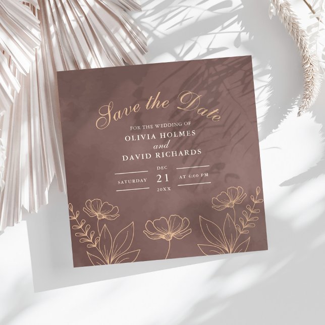 Flores Neutras Encantadas Salvam o Cartão de Data (Enchanted Neutral Blossoms Save The Date Card on a white boho table with dry palm leaf.)