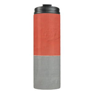 Garrafa Térmica Cinza e parede pintada de laranja
