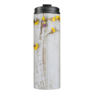 Garrafa Térmica Flores primavera amarelas, decor de prancha branca