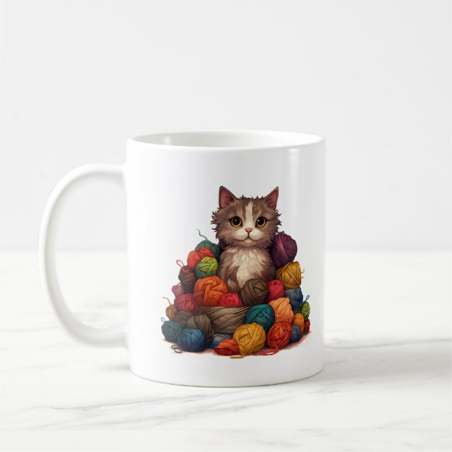Gatinho na caneca de tricô com pilha de fios (Esquerda)