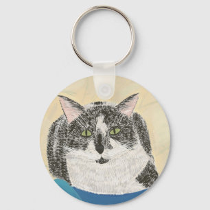 Gato preto e brancoTuxedo sobre chaveiro azul