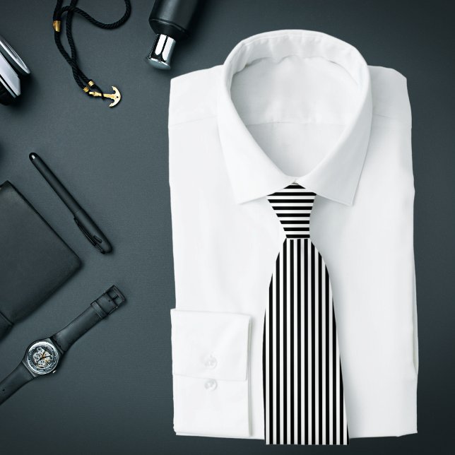 Gravata com Listras Verticais Finas Pretas e Branc (A black and white vertical striped tie is featured on an assemblage of men's accessories.)