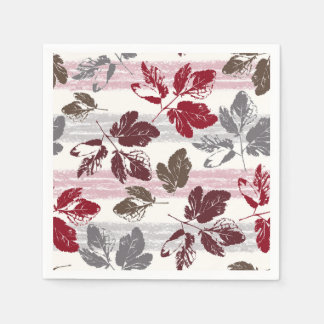 Guardanapo De Papel Folhas multicoloridas em um fundo listrado.