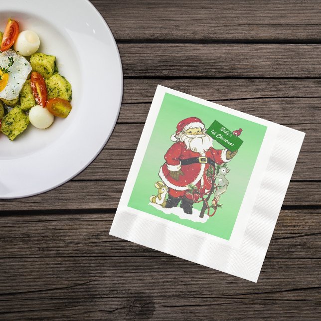 Guardanapo De Papel Primeiro Sinal de Papais noeis de Natal (Cute Santa Clause with tree little forest animals in snow on green Christmas paper napkins.)