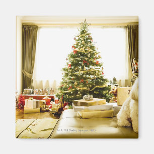 Imã cão que levanta na frente da árvore de Natal