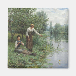 Imã Duas mulheres pescando na grama pelo rio