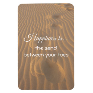 Ímã Felicidade é a citação entre os dedos