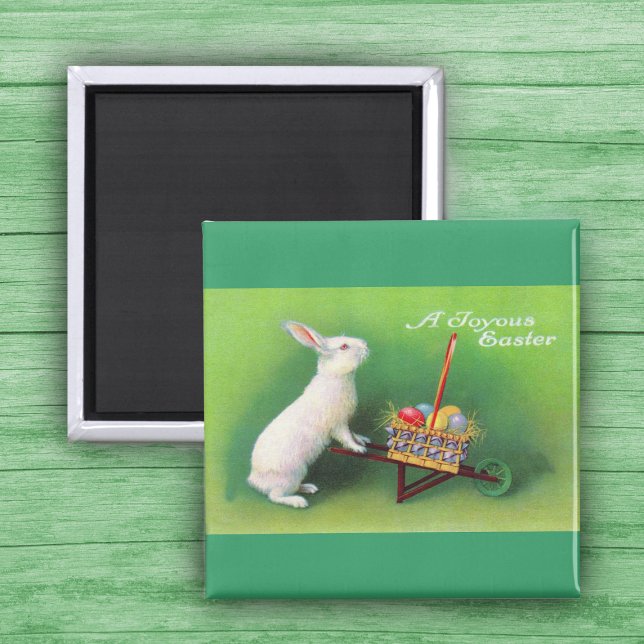Imã Joyous Easter Bunny e Wheelbarrow Magnet (White Easter Rabbit pushing wheelbarrow with coloured Easter Eggs on green Magnet.)