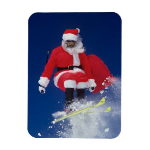 Ímã Papai Noel em esquis saltando de uma coroa em