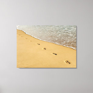 Impressões do pé na areia com onda