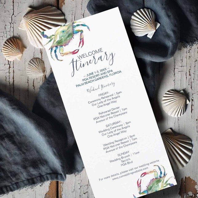 Itinerário de Casamento de Caranguejo (Flat lay of a watercolor crab wedding itinerary card featuring a blue crab illustration)