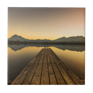 Lago Hopfen com um molhe & as montanhas dos cumes
