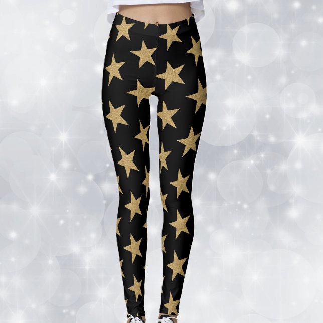 Legging Grandes e Douradas estrelas de Natal em preto (Big festive gold holiday stars on black woman's leggings.)