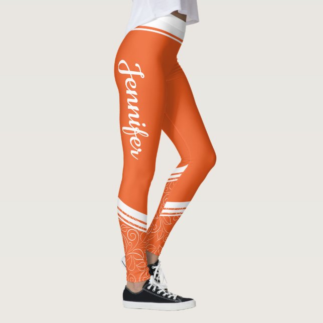 Legging Laranja, listras brancas florais e denominação cin (Direita)