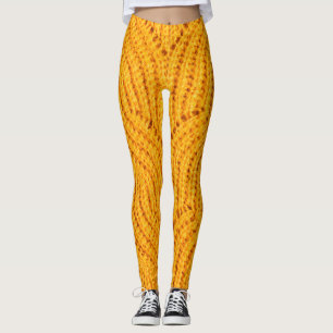 Legging Suéter de malha laranja, fundo texturizado.