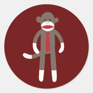 Macaco de sorriso bonito da peúga com etiqueta do