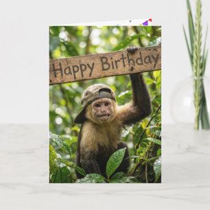 Macaco segurando um cartão de Feliz Aniversário