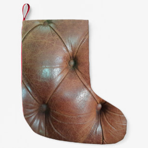 Meia De Natal Pequena Luz na superfície do sofá de couro castanho, textu