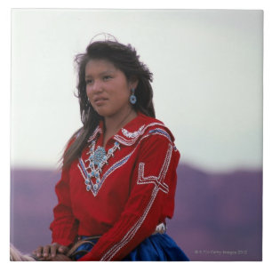 Menina do Navajo a cavalo