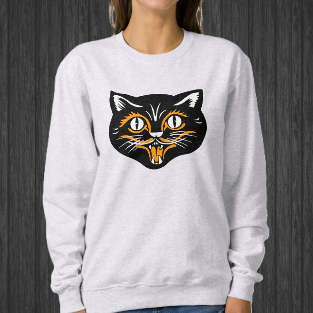 Moletom Feliz Rosto de Gato Preto de Halloween Com Branco  (Happy Black cat face for Halloween with orange and white accents on sweatshirt.)