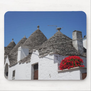 Mousepad Flores do gerânio e casas do trulli em Alberobello