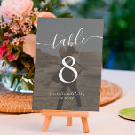 Numeração De Mesa Bold Black White Script Nomes Fotos de casamento<br><div class="desc">Nomes de guião preto e branco marcam casamento,  com uma foto de sobreposição preta,  e adicione sua foto no fundo para um saque de casamento.</div>
