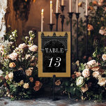 Numeração De Mesa Casamento Dourado Gótico do Arco Negro e Arco Negr<br><div class="desc">Traga seus convidados para um mundo de elegância escura e encantadora com nossa vintage gótica placa de número da mesa de casamento. O fundo amarelo profundo, envelhecido, define a palco para um contraste impressionante, à medida que o texto branco em negrito emerge de intrincadas caixas de texto em preto. No...</div>