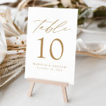 Numeração De Mesa White and Gold Modern Elegance Wedding<br><div class="desc">Trendy, minimalist wedding table number cards featuring gold modern lettering with "Table" in modern calligraphy script. The design features a white background or a color of your choice. The design repeats on the back. To order the table cards: add your name, wedding date, and table number. Add each number to...</div>