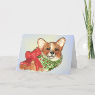 O Corgi com envolve o cartão de Natal