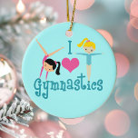 Ornamento De Cerâmica Adoro ginástica<br><div class="desc">Eu Adoro ginástica. Um presente de ginástica bonito com um texto teal adorável entre duas garotas bonitinhas e um belo coração rosa. Um presente de ginasta bonito para crianças ou treinador de ginástica feminina. Uma morena em uma banca e uma menina loira de braços estendidos.</div>