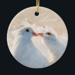 Ornamento De Cerâmica Beijar Doves - Amor<br><div class="desc">Imagem de duas doses brancas de beijos contra o fundo do na moda bege. Texto branco Amor. Engraçado,  romântico,  elegante,  adorável ornamento personalizável. Você pode alterar ou excluir o texto.</div>