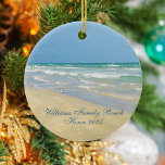 Ornamento De Cerâmica Belo nome da família personalizada da Beach House<br><div class="desc">Belo ornamento de praia com uma fotografia maravilhosa à beira-mar com um sangrento bonito na beira das ondas do oceano num dia ensolarado de verão. Lindas ondas de água verde-azul rolam para a praia arenosa onde seu nome é personalizado em uma tipografia teal fofa. Um belo presente de Natal para...</div>