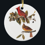 Ornamento De Cerâmica Bookplate de Audubon do vintage dos pássaros do<br><div class="desc">Este par de pássaros do grosbeak cardinal é empoleirado em uma árvore de amêndoa selvagem. O pássaro masculino é um vermelho brilhante e e a fêmea é uma cor dourada com marcações vermelhas. Este é o bookplate 159 dos pássaros de John James Audubon de América. Os enfeites de natal perfeitos...</div>