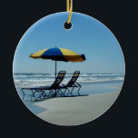 Ornamento De Cerâmica Cadeiras de praia em Daytona Beach<br><div class="desc">Uma fotografia de relaxamento da praia que mostre 2 cadeiras de praia e um guarda-chuva azul e amarelo que se senta na linha costeira de Daytona Beach, Florida. Esta fotografia da praia está disponível em cartões personalizados, em selos postais, em canecas, em sacolas, em caixas de presente, em portas copos,...</div>