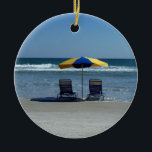 Ornamento De Cerâmica Cadeiras de praia na linha costeira<br><div class="desc">Uma fotografia de cena bonita da praia que caracterizam 2 cadeiras de praia e um guarda-chuva que senta-se na linha costeira de Daytona Beach. Uma vista cénico calma da praia está disponível em muitos produtos personalizados que fariam grandes presentes da praia para amigos e família.</div>