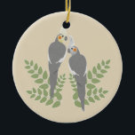 Ornamento De Cerâmica Casal do Cockatiel<br><div class="desc">Casal romântico do cockatiel com folhas. cor customizável do fundo.</div>