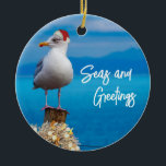Ornamento De Cerâmica Christmas Beach Seas and Greetings Seagull Ocean<br><div class="desc">This design may be personalized by choosing the Edit Design option. You may also transfer onto other items. Contact me at colorflowcreations@gmail.com or use the chat option at the top of the page if you wish to have this design on another product or need assistance. See more of my designs...</div>