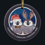 Ornamento De Cerâmica Christmas Penguin Couple Cute Santa and Reindeer<br><div class="desc">Christmas Penguin Couple Cute Santa and Reindeer - ideal as a "our first Christmas as newly weds" - tree ornaments from Ricaso - easy to personalize with your own details - designed with two adorable penguins - one wearing a Santa hat the other in antlers on a snow blue background...</div>
