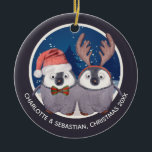 Ornamento De Cerâmica Christmas Penguin Couple Cute Santa and Reindeer<br><div class="desc">Christmas Penguin Couple Cute Santa and Reindeer - ideal as a "our first Christmas as newly weds" - tree ornaments from Ricaso - easy to personalize with your own details - designed with two adorable penguins - one wearing a Santa hat the other in antlers on a snow blue background...</div>
