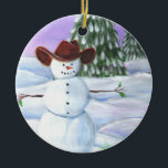 Ornamento De Cerâmica Cowboy Snowman<br><div class="desc">Cowboy Snowman ilustrou a fotografia. Ele veste um chapéu de cowboy marrom,  sentado em rolos de neve com pinheiros e pôr do sol roxo ao fundo.</div>