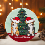 Ornamento De Cerâmica Dois Corgi Tricolor Red White Santa Hat Natal<br><div class="desc">Este lindo ornamento de cachorro Pembroke Welsh Corgi mostra dois cachorros vestindo chapéus de Papai Noel com uma adorável inclinação da cabeça. Um filhote tricolor e um cão vermelho e branco sentados em frente a uma árvore de Natal bonito decorada com ornamentos coloridos. Personalize os nomes dos seus animais de...</div>